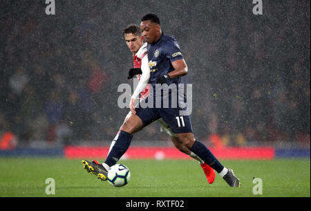 Arsenal's Denis Suarez (left) and Manchester United's Anthony Martial battle for the ball during the Premier League match at the Emirates Stadium, London. Stock Photo