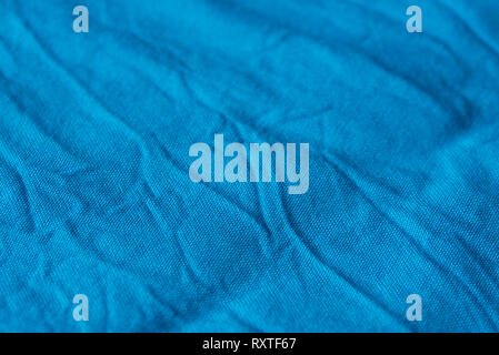 creased blue color  textile texture background selective focus Stock Photo