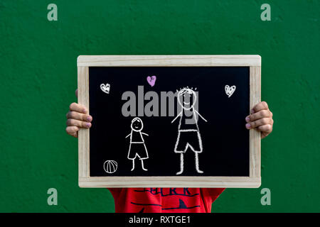 boy with chalkboard displaying Happy Father's Day drawing in chalk. Stock Photo