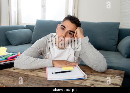 Overworked and tired university or high school male student working and studying bored and overwhelmed trying not to fall asleep. In studying for fina Stock Photo