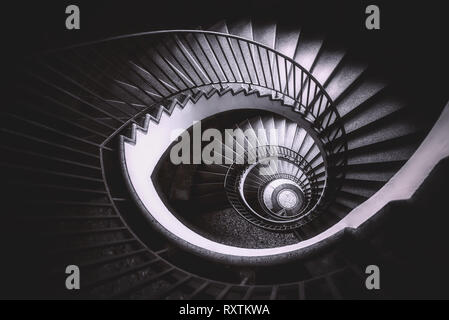 an abstract detail of a spiral staircase in an old building, black and white, monochromatic Stock Photo