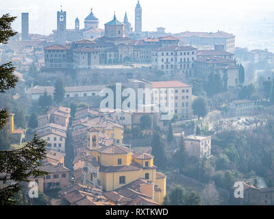 Travel to Italy - above view of Citta Alta (Upper town) of Bergamo city from San Vigilio hill in spring haze Stock Photo