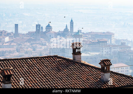 Travel to Italy - above view of Citta Alta (Upper town) of Bergamo city from San Vigilio castel in spring haze Stock Photo