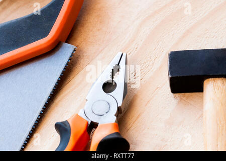 Hammer, nails and pliers lie on a wooden background. Construction Tools Selective Focus Stock Photo