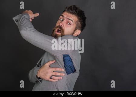 Hipster with beard with ripped hole on seam. Fashion model wear small ...