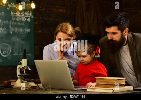 Pretty teacher helping pupil in classroom at the elementary school, Teacher respects students, Education and literacy concept - high school teachers Stock Photo