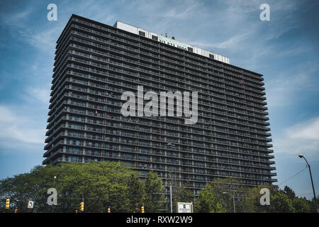 Detroit, Michigan USA - April 7th, 2018: A huge wall wall of aparment buildings on an empty boulevard. Stock Photo