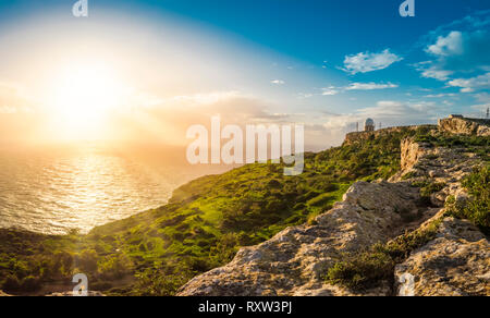 Dingli Cliffs, Malta: Panoramic road with a romantic view over Dingli Cliffs and Aviation radar at sunset with the rays of setting sung