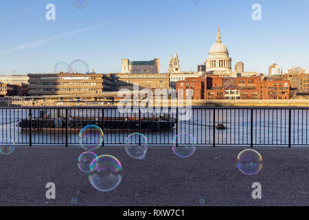 LONDON, UK – Dec 13, 2018: Performer blowing soup bubbles on an abeautiful sunny day on the bank of River Thames London Stock Photo