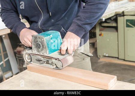 Worker man concept. Male carpenter working in his carpentry workshop. Stock Photo
