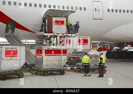 BUDAPEST, HUNGARY - DECEMBER 01, 2015: Emirates Boeing 777-300 being loaded with cargo containers at Budapest Airport. Stock Photo