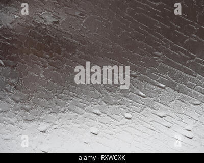 Close up of an icy, frost-covered window with a pattern of spikes and ridges. Stock Photo