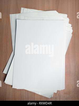 Stack white paper template on work table with Clipping Path Stock Photo