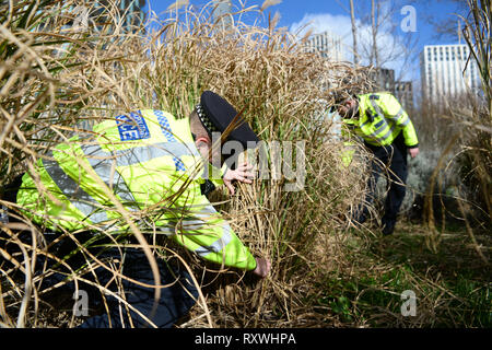 Officers from the Metropolitan Police search for weapons in Cornmill Gardens in Lewisham, south London, as part of Operation Sceptre, which will see forces across England and Wales using surrender bins, stop-and-search and weapons sweeps in a concerted crackdown on knife crime. Stock Photo