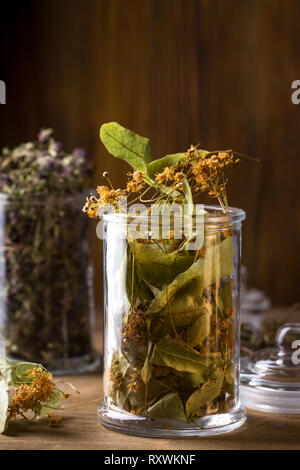 Dry linden flowers in a glass jar, top view Stock Photo