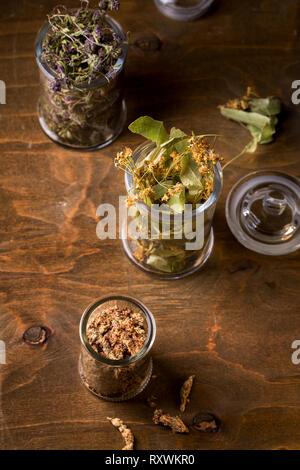 Dry linden flowers in a glass jar, top view Stock Photo