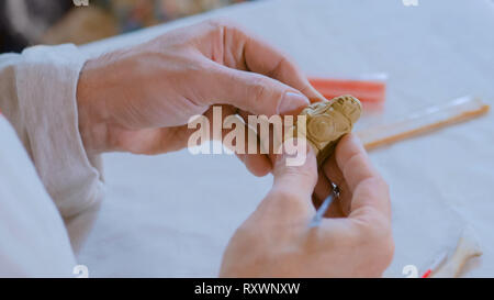 Potter making clay figure for board game Stock Photo