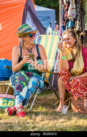 Two ladies having a laugh at Into the Wild festival, Kent, UK Stock Photo