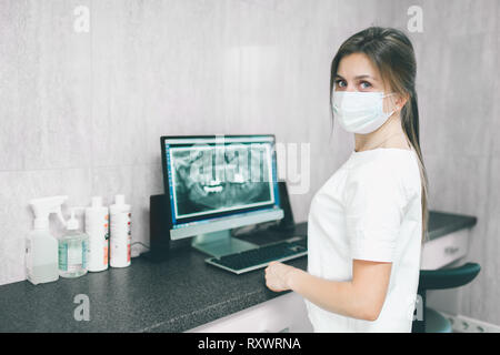 Portrait of female dentist .She standing in her dentist office. Stock Photo