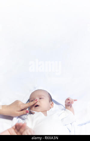 Mother touching nose of little cute newborn baby boy. Banner size photo with copy space Stock Photo