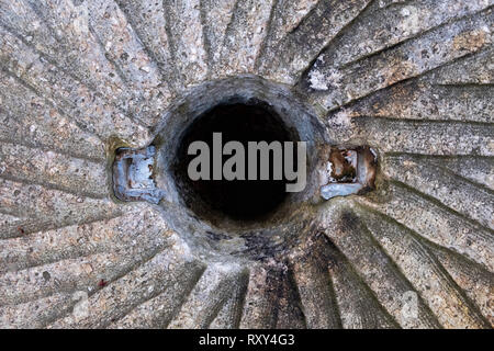 A top symmetrical view of an old millstone used to grind corn or wheat at the gristmill many years ago at Historic Yates Mill County Park in Raleigh N Stock Photo