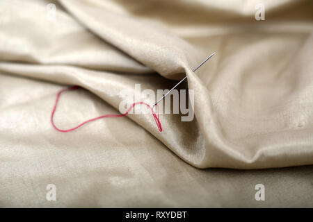 Picture of thread and needle attached in cloth. Stock Photo