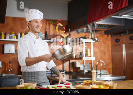 Professional Chef Cooking in Restaurant Stock Photo
