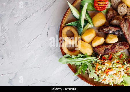 Delicious restaurahnt appetizers set for beer. Delicious restaurant appetizers set for beer. vegetable salad, boiled potatoes, grilled chicken legs Stock Photo