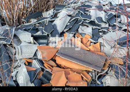 broken tiles black, gray and orange color close up Stock Photo