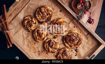 Buns with chocolate and cinnamon as cake food concept. Top view. Stock Photo