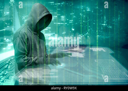 Hacker in black hoodie touching virtual screen on the table with server data, binary code, bar graph and world map with green background Stock Photo