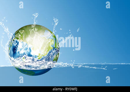 Earth planet on the water with splash over blue background. Earth hour concept Stock Photo