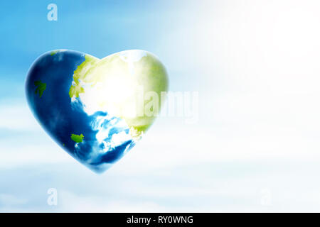 Earth planet with heart shape over blue sky background. Earth hour concept Stock Photo
