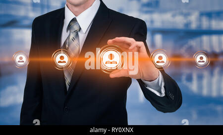 Human resource business concept. Businessman presses hr icon on virtual screen Stock Photo