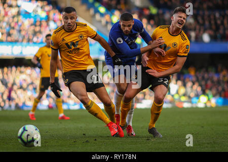 London, UK. 10th Mar, 2019. Ruben Loftus-Cheek of Chelsea battles with Romain Saiss (left) and Leander Dendoncker (right) of Wolverhampton Wanderers - Chelsea v Wolverhampton Wanderers, Premier League, Stamford Bridge, London - 10th March 2019 Editorial Use Only - DataCo restrictions apply Credit: MatchDay Images Limited/Alamy Live News Stock Photo