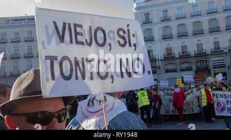 Madrid, Spain. 11th Mar, 2019. The unions protested at Puerta del Sol in Madrid  against cuts in pensions gathering hundreds of people.  In the picture, one of the people at the protest with a placard that says “Old yes, stupid no.” Credit: Lora Grigorova/Alamy Live News Stock Photo