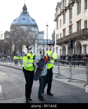 London, UK. 11th Mar, 2019. One young man and two of his friends on skateboards is removed by police from the safety zone near Westminster Abbey, just after the Commonwealth Day Service today. Credit: Joe/Alamy Live News Stock Photo