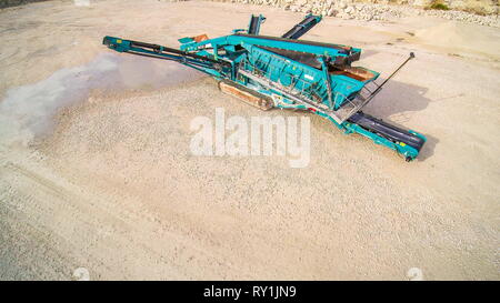 The limestone crusher in the middle of the quarry. This heavy equipment ...