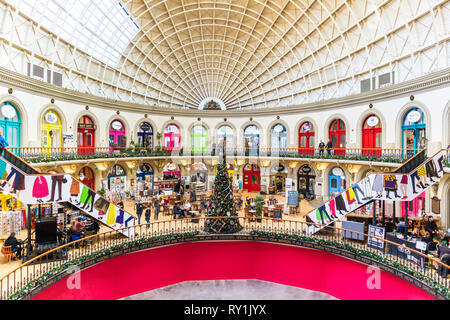A mixed variety of small shops and cafes in the Victorian Corn Exchange, Leeds, West Yorkshire UK Stock Photo