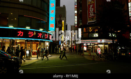 Tokyo, Japan - October 15 2018 : Neon signs and shop windows brightly light this night shot of downtown Tokyo in Japan. Stock Photo