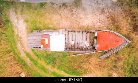 Aerial shot of the boat in the Vergi Estonia. Its an old wooden boat in the middle of the rocky ground Stock Photo