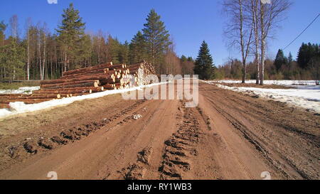 The view of the street where the logs are being piled up on the street side Stock Photo