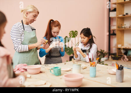Group of Kids in Pottery Class Stock Photo