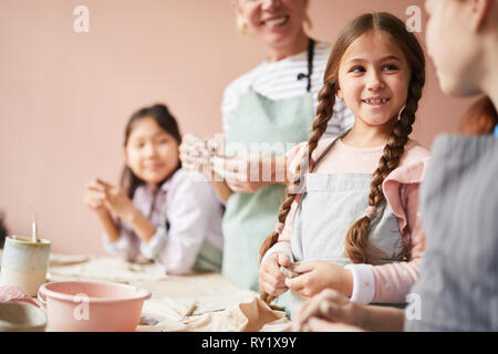 Cute Girl in Pottery Workshop Stock Photo