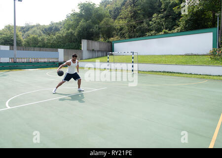 Basketball Player Bodybuilder Practicing And Posing For Basketball And Sports Athlete Concept Stock Photo