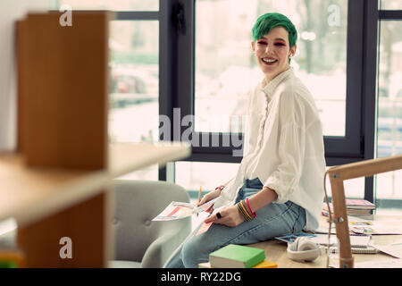 Cheerful positive nice woman being at work Stock Photo