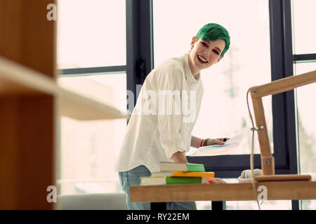 Delighted happy woman enjoying her creative job Stock Photo
