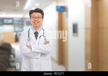Asian male doctor smiling in the background of the hospital. Stock Photo