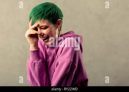 Delighted positive happy woman touching her forehead Stock Photo