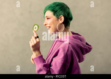 Nice cheerful woman standing with a lollipop in her hands Stock Photo